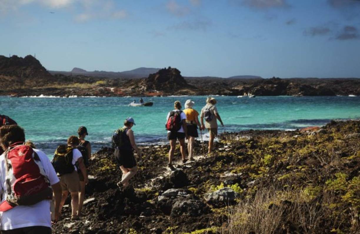 A man walks before a residential apartments in Hong Kong on May 16, 2015. AFP PHOTO / DALE DE LA REY (Photo credit should read DALE de la REY/AFP/Getty Images)