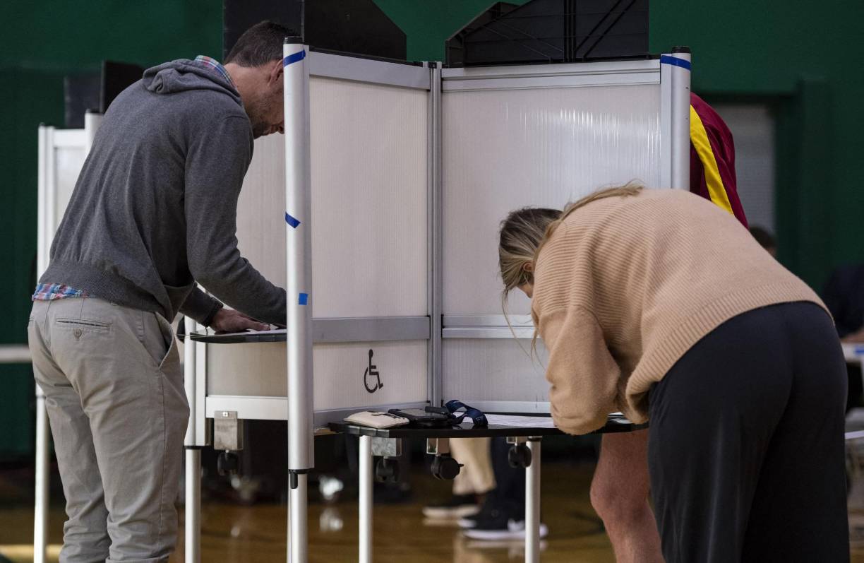 People fill out their ballots at Cathedral High School in Boston, Massachusetts on November 8, 2022. (Photo by Joseph Prezioso / AFP)