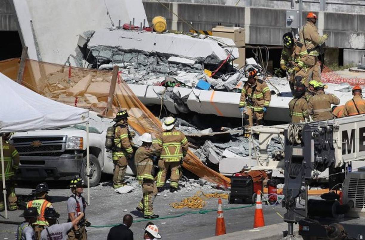 MIAMI, FL - MARCH 15: Miami-Dade Fire Rescue Department personel and other rescue units work at the scene where a pedestrian bridge collapsed a few days after it was built over southwest 8th street allowing people to bypass the busy street to reach Florida International University on March 15, 2018 in Miami, Florida. Reports indicate that there are an unknown number of fatalities as a result of the collapse, which crushed at least five cars. Joe Raedle/Getty Images/AFP<br/><br/>== FOR NEWSPAPERS, INTERNET, TELCOS & TELEVISION USE ONLY ==<br/><br/>