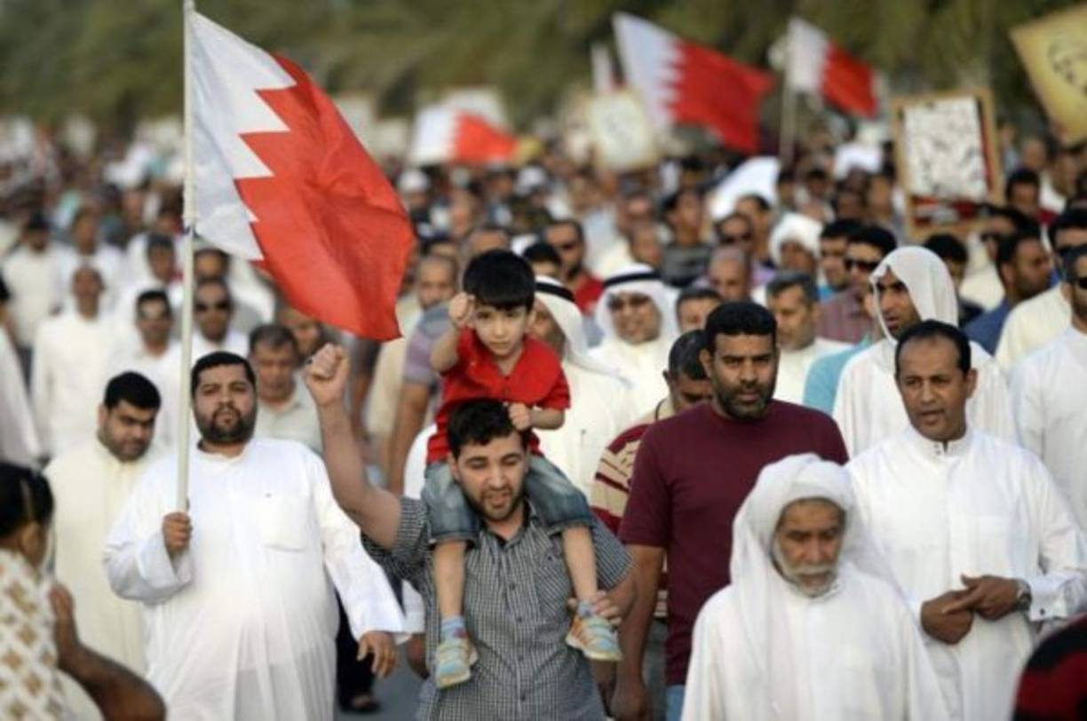 A young woman receives a COVID-19 vaccine at the Bahrain International Exhibition and Convention Center in the capital Manama, on December 24, 2020. - In Bahrain, which has recorded more than 90,000 cases including 350 deaths, vaccinations continued today. It has approved both the Pfizer-BioNTech vaccine and another developed by Chinese firm Sinopharm. (Photo by Mazen Mahdi / AFP)