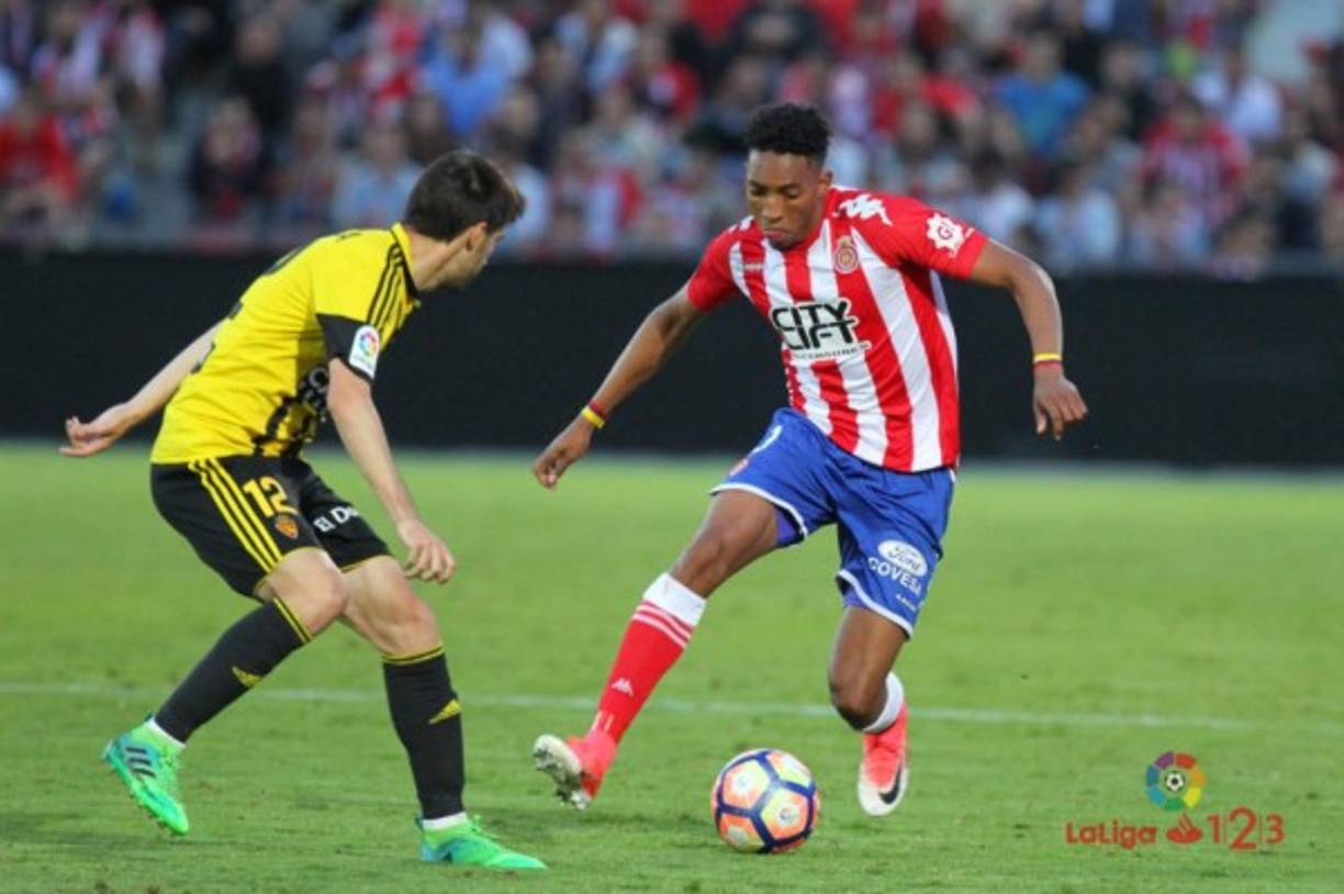 Barcelona's Argentinian forward Lionel Messi (L) celebrates with Barcelona's Spanish defender Jordi Alba after scoring a goal during the Spanish league football match between Girona FC and FC Barcelona at the Montilivi stadium in Girona on January 27, 2019. (Photo by LLUIS GENE / AFP)