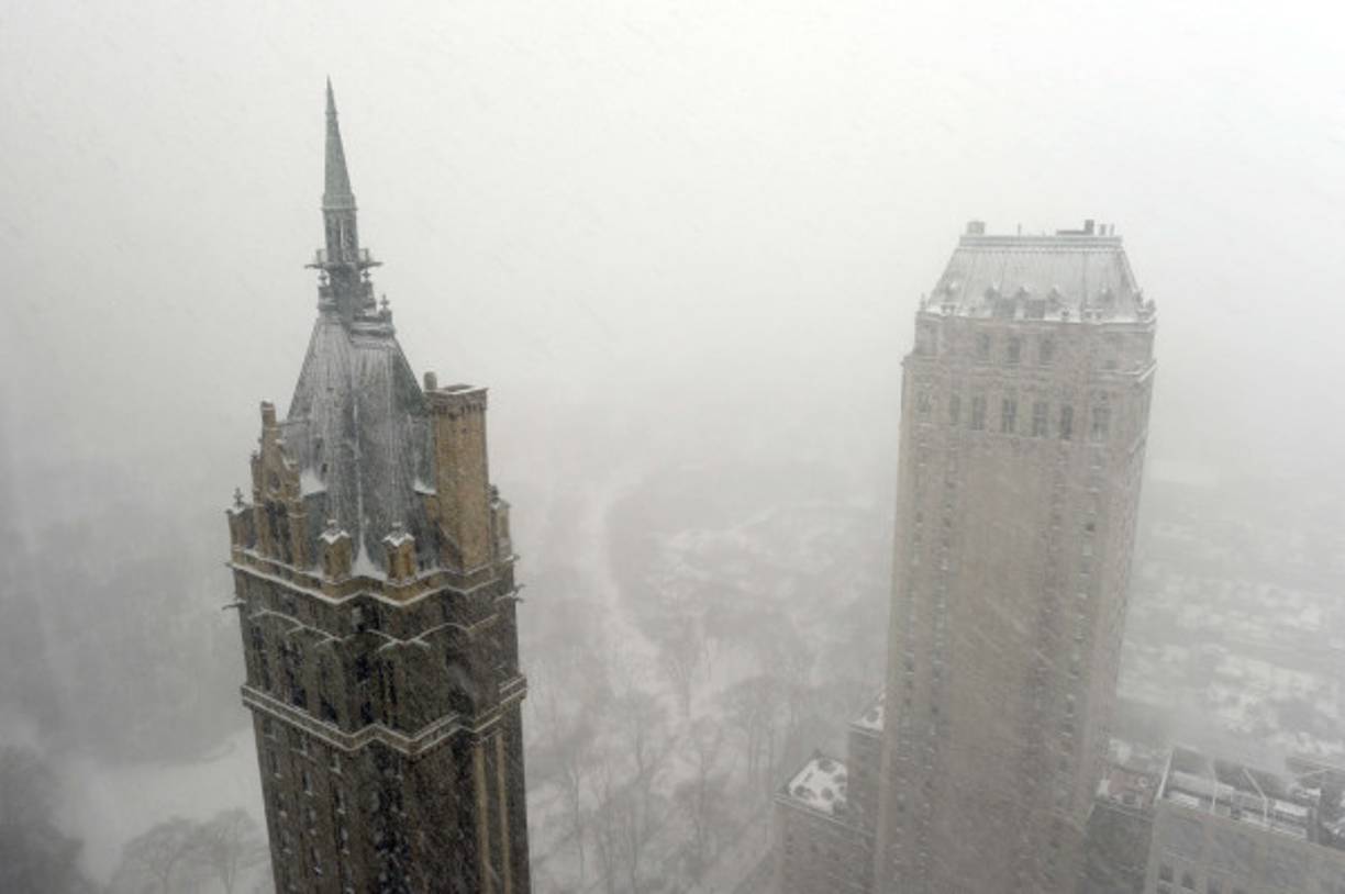 Two people sit ane chat on a bench in a quiet Central Park in New York on Thursday, March 26, 2020. (Tyler Sizemore/Hearst Connecticut Media via AP)