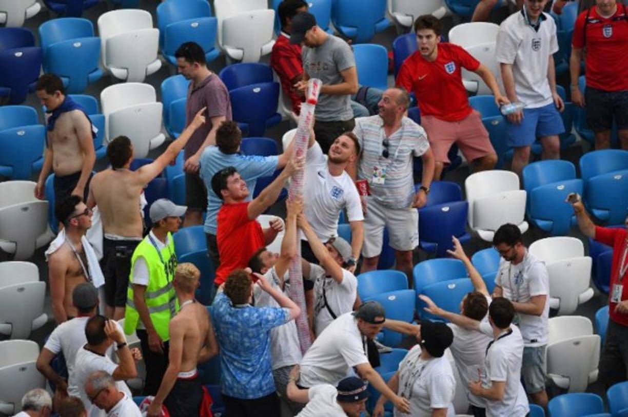 Un grupo de aficionados ingleses hacen una torre de vasos cerveceros.