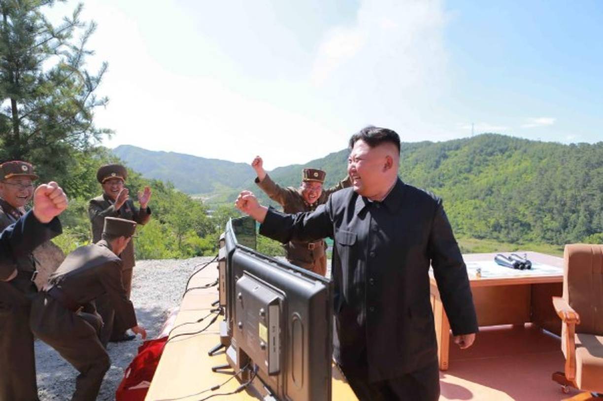 This picture taken and released on July 4, 2017 by North Korea's official Korean Central News Agency (KCNA) shows North Korean leader Kim Jong-Un (R) reacting after the test-fire of the intercontinental ballistic missile Hwasong-14 at an undisclosed location.<br/>North Korea declared on July 4 it had successfully tested its first intercontinental ballistic missile -- a watershed moment in its push to develop a nuclear weapon capable of hitting the mainland United States. / AFP PHOTO / KCNA VIA KNS / STR / South Korea OUT / REPUBLIC OF KOREA OUT ---EDITORS NOTE--- RESTRICTED TO EDITORIAL USE - MANDATORY CREDIT 'AFP PHOTO/KCNA VIA KNS' - NO MARKETING NO ADVERTISING CAMPAIGNS - DISTRIBUTED AS A SERVICE TO CLIENTS<br/>THIS PICTURE WAS MADE AVAILABLE BY A THIRD PARTY. AFP CAN NOT INDEPENDENTLY VERIFY THE AUTHENTICITY, LOCATION, DATE AND CONTENT OF THIS IMAGE. THIS PHOTO IS DISTRIBUTED EXACTLY AS RECEIVED BY AFP. <br/> /