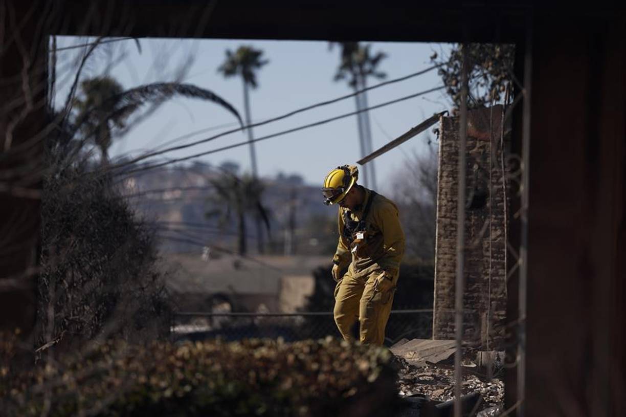 Entre viviendas intactas y otras completamente carbonizadas, elegidas al azar de los fuertes vientos que golpearon la zona, el barrio se ha teñido de tonos grisáceos y negros, con el sonido de alarmas de fondo y los bomberos trabajando sin descanso en algunas estructuras de las que todavía emergen columnas de humo.