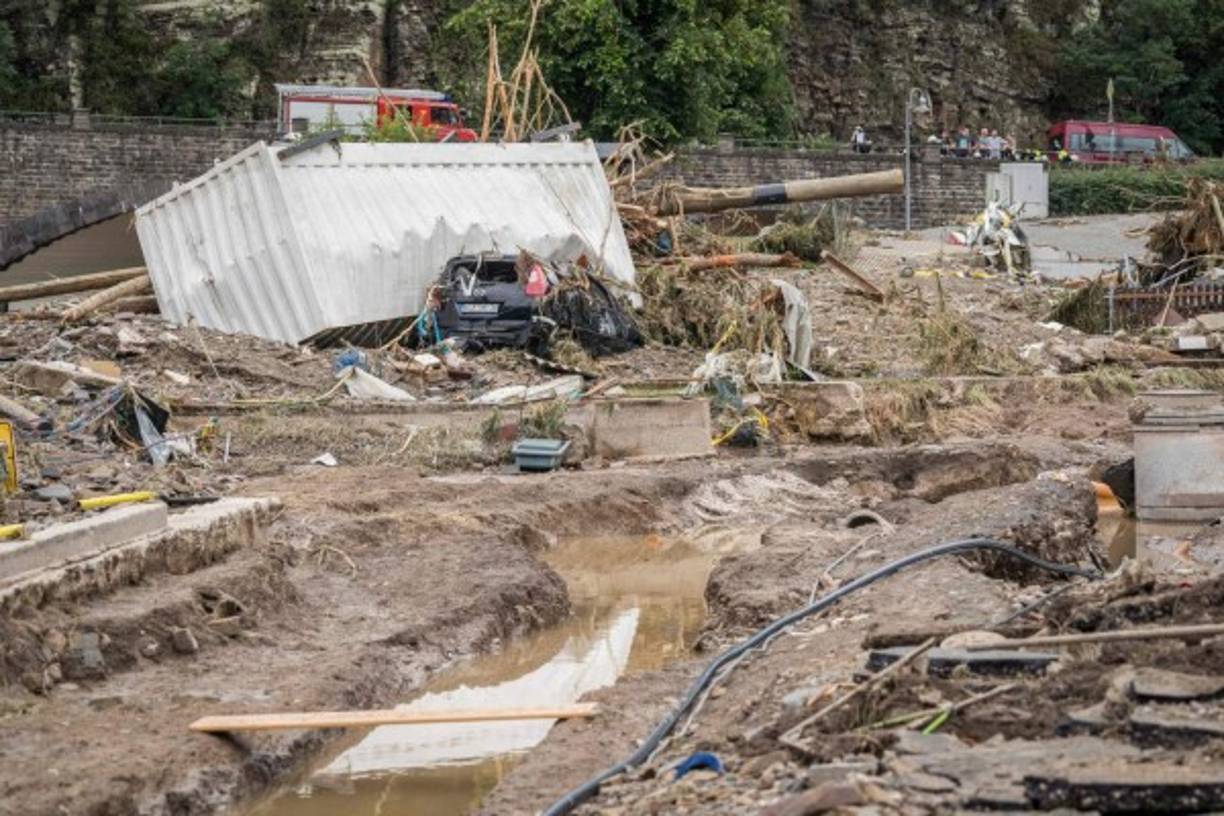 A destroyed car lies under a container amid debris following important floods in Schuld near Bad Neuenahr, western Germany, on July 15, 2021. - Heavy rains and floods lashing western Europe have killed at least 45 people in Germany and left around 50 missing, as rising waters led several houses to collapse. (Photo by Bernd Lauter / AFP)