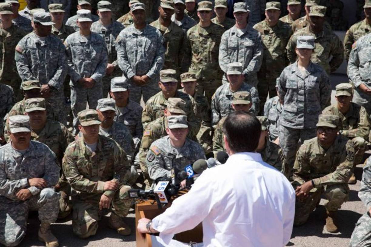 Members of the Arizona National Guard listen to Arizona Gov. Doug Ducey on April 9, 2018 at the Papago Park Military Reservation in Phoenix, Arizona. <br/>Arizona deployed its first 225 National Guard members to the Mexican border on Monday after President Donald Trump ordered thousands of troops to the frontier region to combat drug trafficking and illegal immigration. 'The Arizona National Guard will deploy 225 members of the Guard today to support border security measures,' the state militia said in a statement.<br/> / AFP PHOTO / Caitlin O'Hara