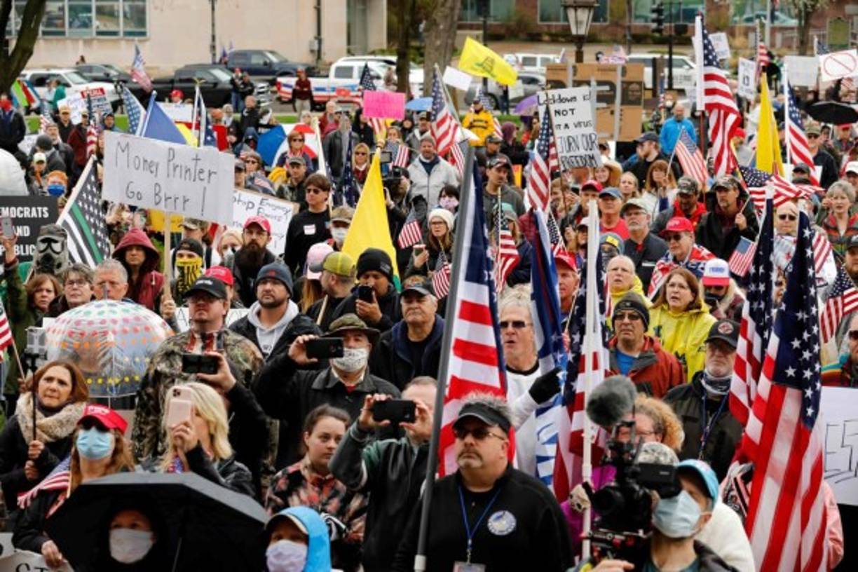 Demonstrators take part in an 'American Patriot Rally,' organized on April 30, 2020, by Michigan United for Liberty on the steps of the Michigan State Capitol in Lansing, demanding the reopening of businesses. - The group is upset with Michigan Gov. Gretchen WhitmerÕs mandatory closure to curtail Covid-19. (Photo by JEFF KOWALSKY / AFP)