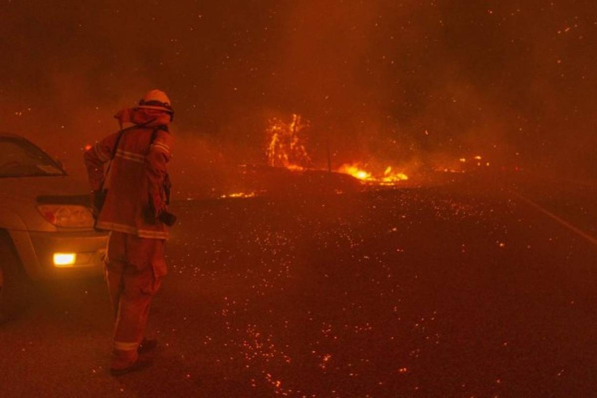 SHAVER LAKE, CA - SEPTEMBER 8: Embers fall around a photographer as the Creek Fire rapidly expands on September 8, 2020 near Shaver Lake, California. California Gov. Gavin Newsom declared a state of emergency in five California counties late yesterday as record heatwave temperatures fueled numerous wildfires over the Labor Day weekend. The state of emergency applies to Fresno, Madera and Mariposa, San Bernardino and San Diego counties. The Creek Fire has burned across more than 135,523 acres and is zero percent contained. David McNew/Getty Images/AFP<br/><br/>== FOR NEWSPAPERS, INTERNET, TELCOS & TELEVISION USE ONLY ==<br/><br/>