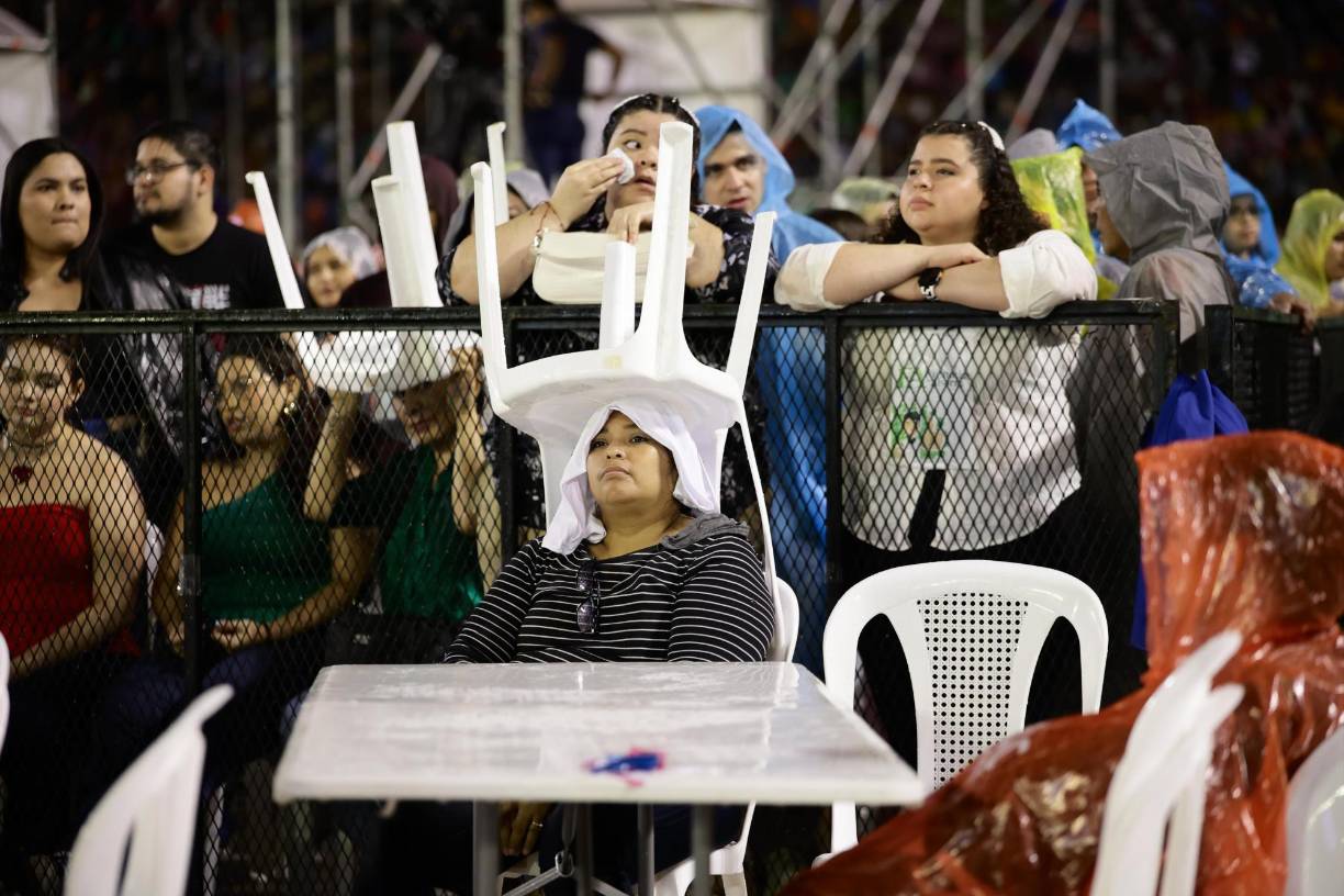 Esta dama captó la atención por su ingeniosa forma de sostener la silla, para no cansarse se puso una camiseta en la cabeza y así la silla le quedó estable. 
