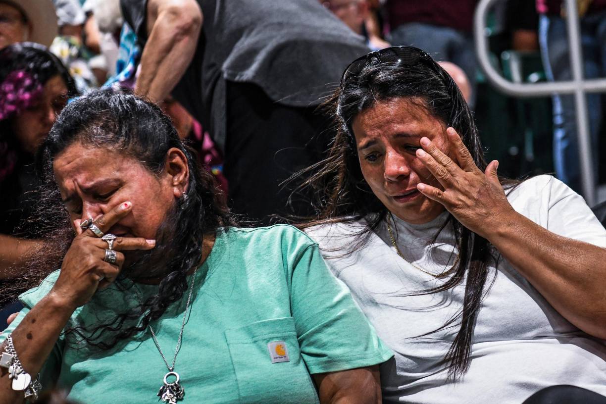 TOPSHOT - People mourn as they attend the vigil for the victims of the mass shooting at Robb Elementary School in Uvalde, Texas on May 25, 2022. - The tight-knit Latino community of Uvalde was wracked with grief Wednesday after a teen in body armor marched into the school and killed 19 children and two teachers, in the latest spasm of deadly gun violence in the US. (Photo by CHANDAN KHANNA / AFP)