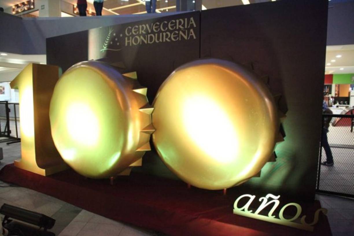 El emblema del centenario se creó fusionando dos enormes tapitas en imponente tono dorado.