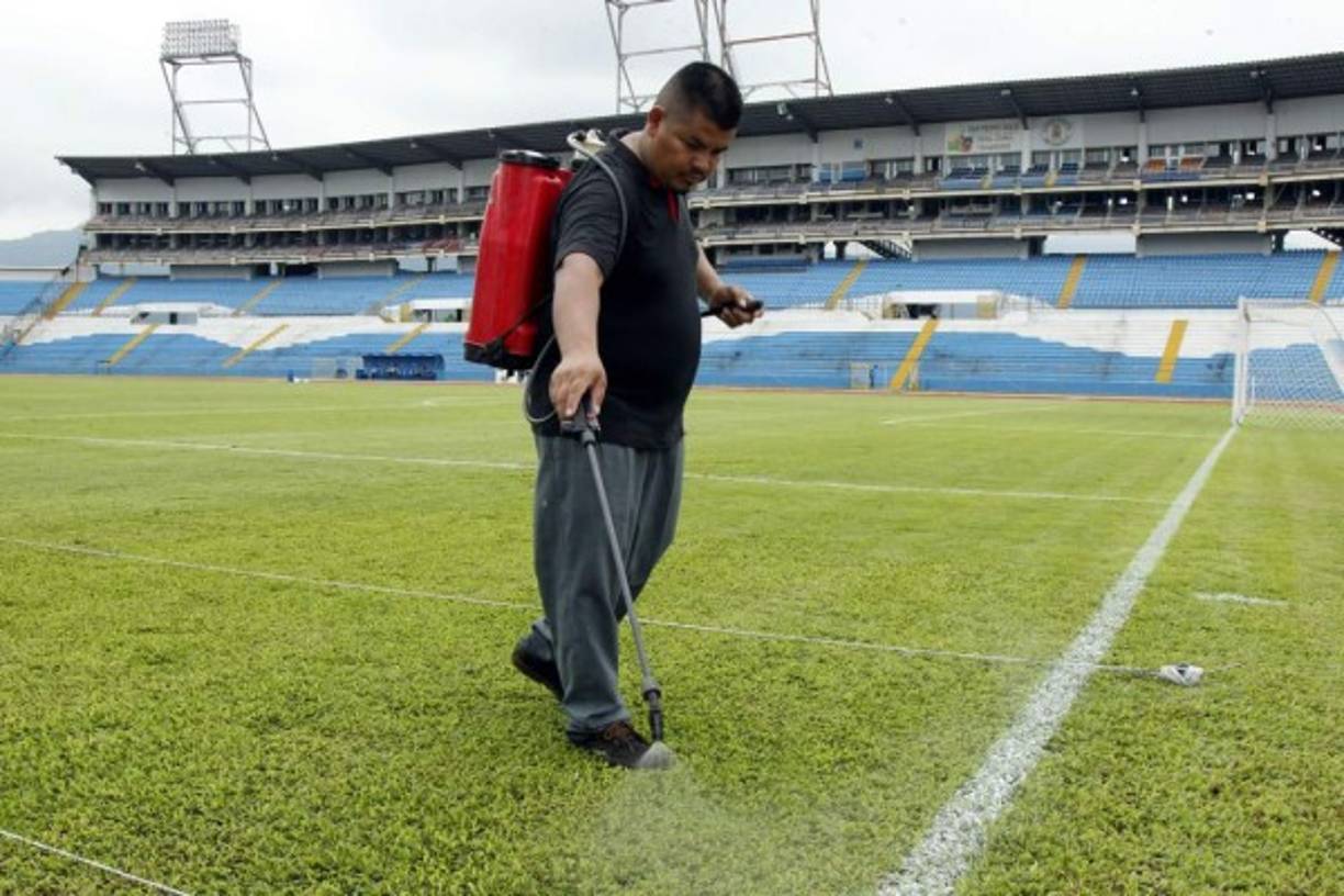 Personal mantenimiento del estadio Olímpico ultima detalles en la cancha.