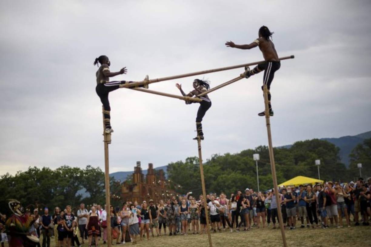Togolese stilt walker group 'Afuma' performs during the 41st edition of Paleo on July 20, 2016 in Nyon, the biggest open-air music festival in Switzerland. / AFP PHOTO / FABRICE COFFRINI
