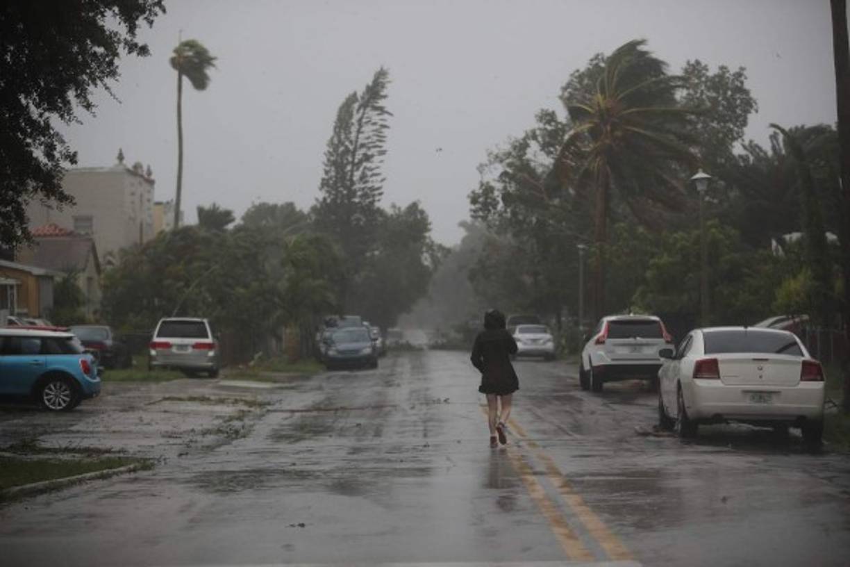 MIAMI, FL - SEPTEMBER 10: Jonvi Delsol checks out what is happening on her street as high winds and rain from hurricane Irma arrive on September 10, 2017 in Miami, Florida. Florida will take a hit by the Hurricane which will come ashore at category 4. Joe Raedle/Getty Images/AFP<br/><br/>== FOR NEWSPAPERS, INTERNET, TELCOS & TELEVISION USE ONLY ==<br/><br/>