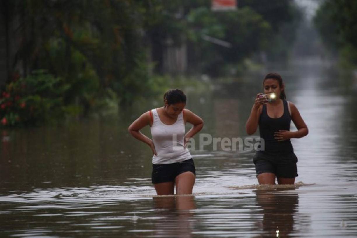 Estas jovencitas caminar con el agua hasta las rodillas.