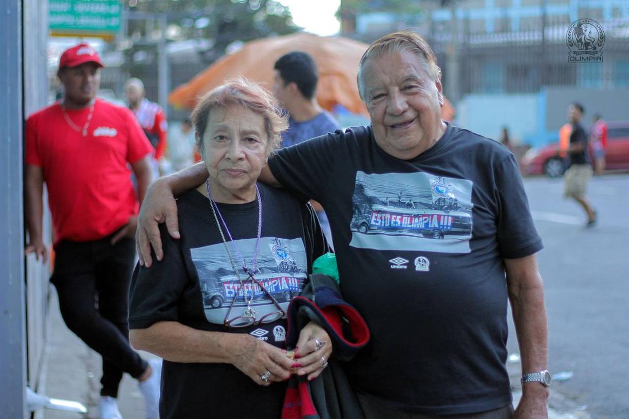 Los aficionados que nunca fallan en el Nacional. Esta pareja siempre llega con sus camisetas especiales del Olimpia.