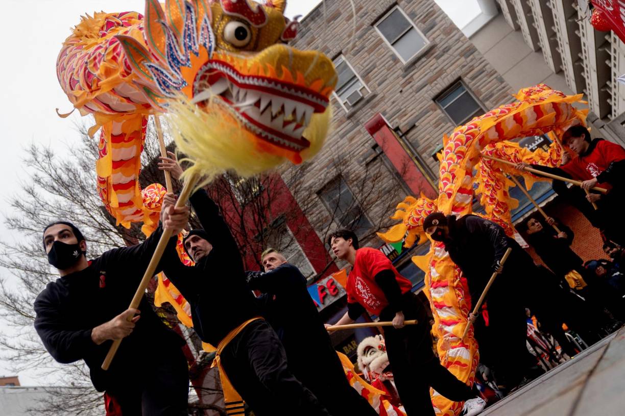 Performers dance on stage following the Lunar New Year Parade in the Chinatown neighborhood of Washington, DC, on January 22, 2023. - 2023 is the year of the rabbit in the Chinese horoscope. (Photo by Stefani Reynolds / AFP)