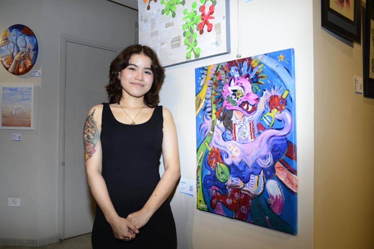 La artista “Zanate” junto su cuadro pictórico llamado “La yaguara”