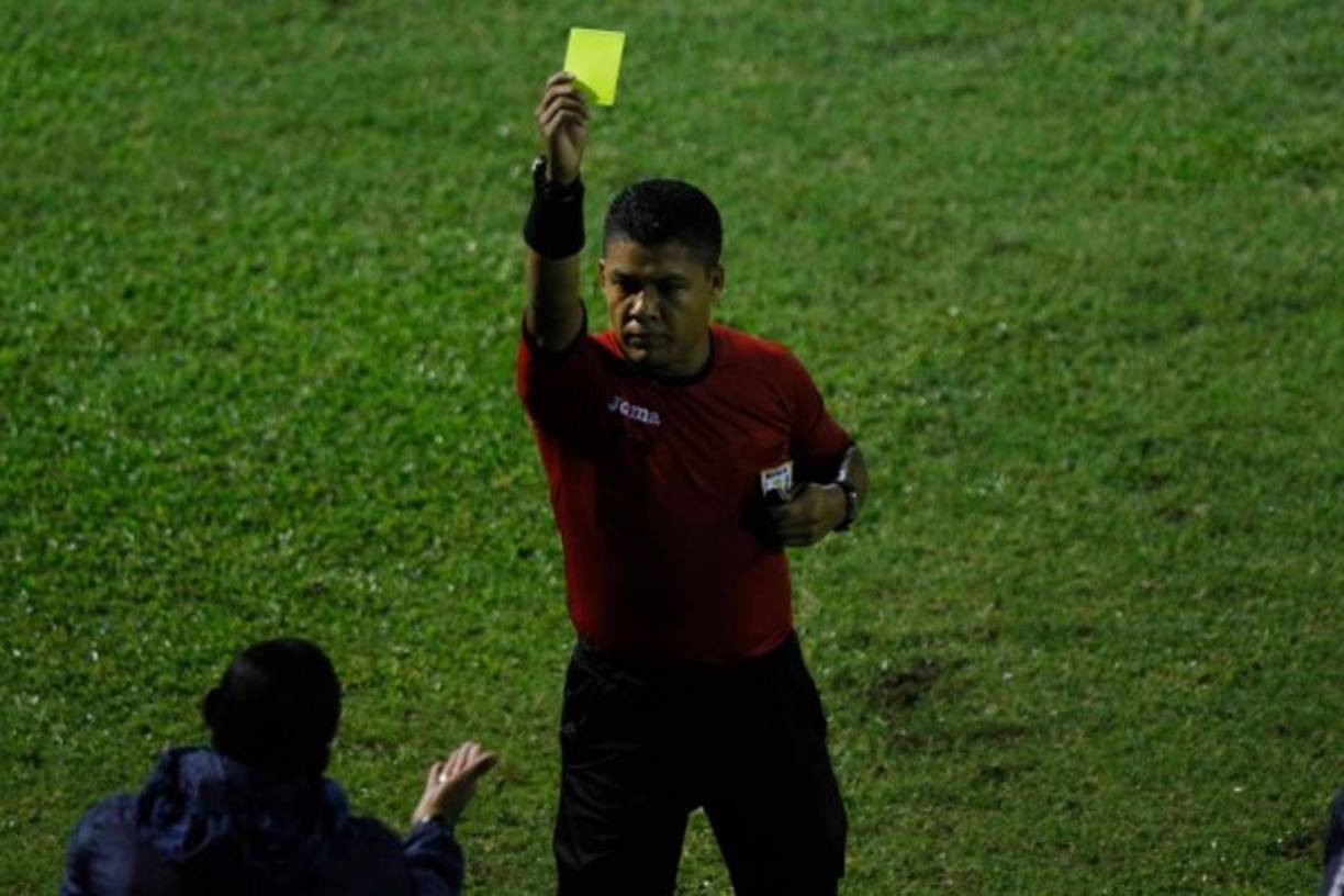 El árbitro Armando Castro le muestra tarjeta amarilla al entrenador del Real de Minas, Raúl Cáceres.