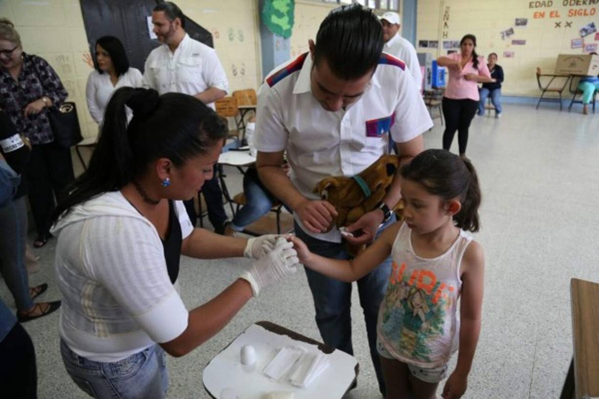 Ni el peluche dejó esta pequeña en casa que no quiso perderse la fiesta cívica y conocer desde ya cómo es el proceso de votación. De forma simbólica le manchan el dedo como recuerdo de la jornada.