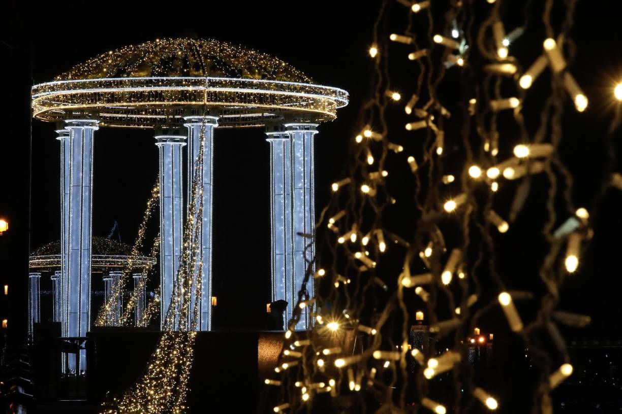 La gente camina a lo largo del Puente del Palacio, decorado estacionalmente antes de las celebraciones de año Nuevo y Navidad, en San Petersburgo.