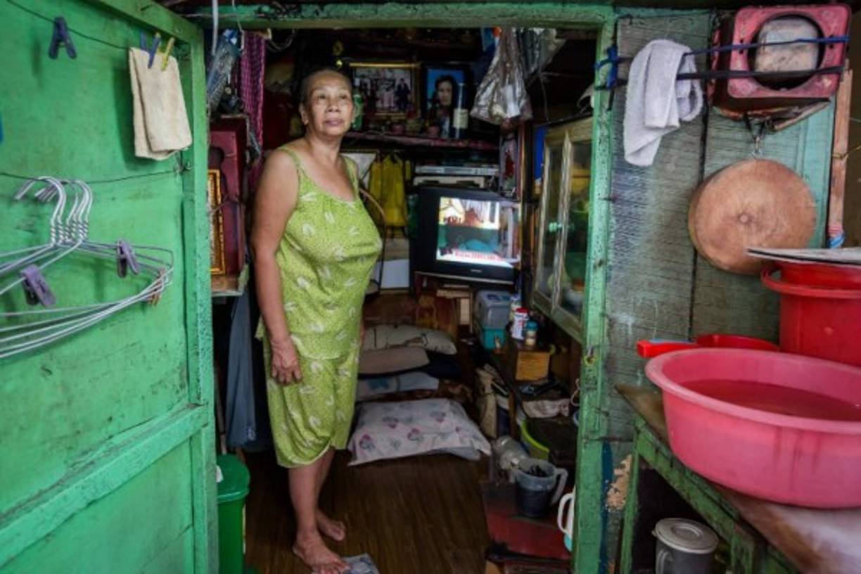Kha Tu Ngoc is seen inside her two-square-meter house in Ho Chi Minh City on May 2, 2018.<br/>The 'micro-house' dwellings are dotted throughout Vietnam's bustling southern hub, occupied by families clinging to postage stamp-sized plots a city developing at breakneck pace. Tucked away in winding alleys, nestled under new condo developments or sandwiched between street food stalls and shops, the tiny houses are easily missed by the unattentive passerby. / AFP PHOTO / Thanh NGUYEN