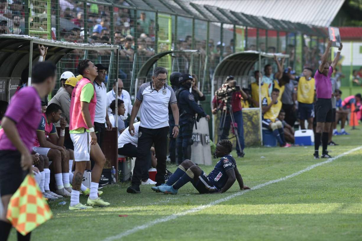 Carlos Mejía del Motagua tendido a un costado del campo ante la mirada de Salomón Nazar.