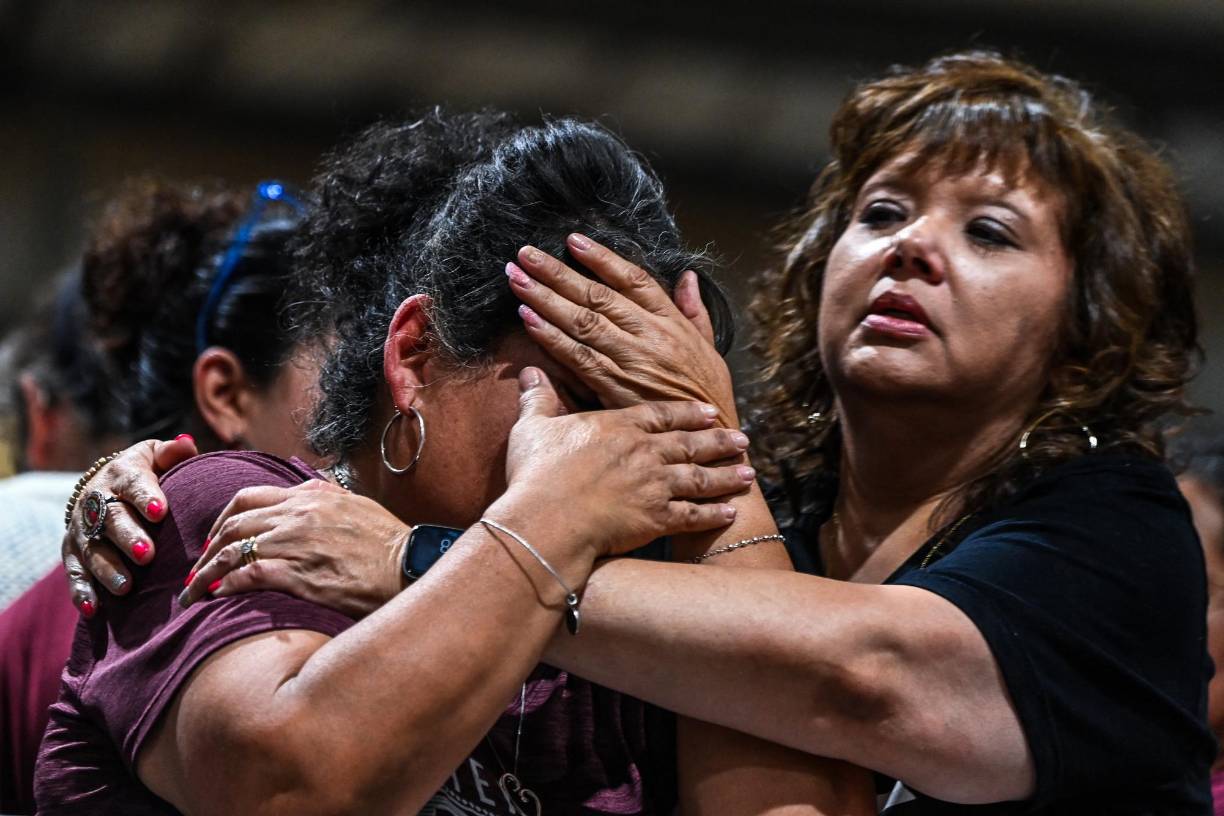 A woman cries as she attends the vigil for the victims of the mass shooting at Robb Elementary School in Uvalde, Texas on May 25, 2022. - The tight-knit Latino community of Uvalde was wracked with grief Wednesday after a teen in body armor marched into the school and killed 19 children and two teachers, in the latest spasm of deadly gun violence in the US. (Photo by CHANDAN KHANNA / AFP)