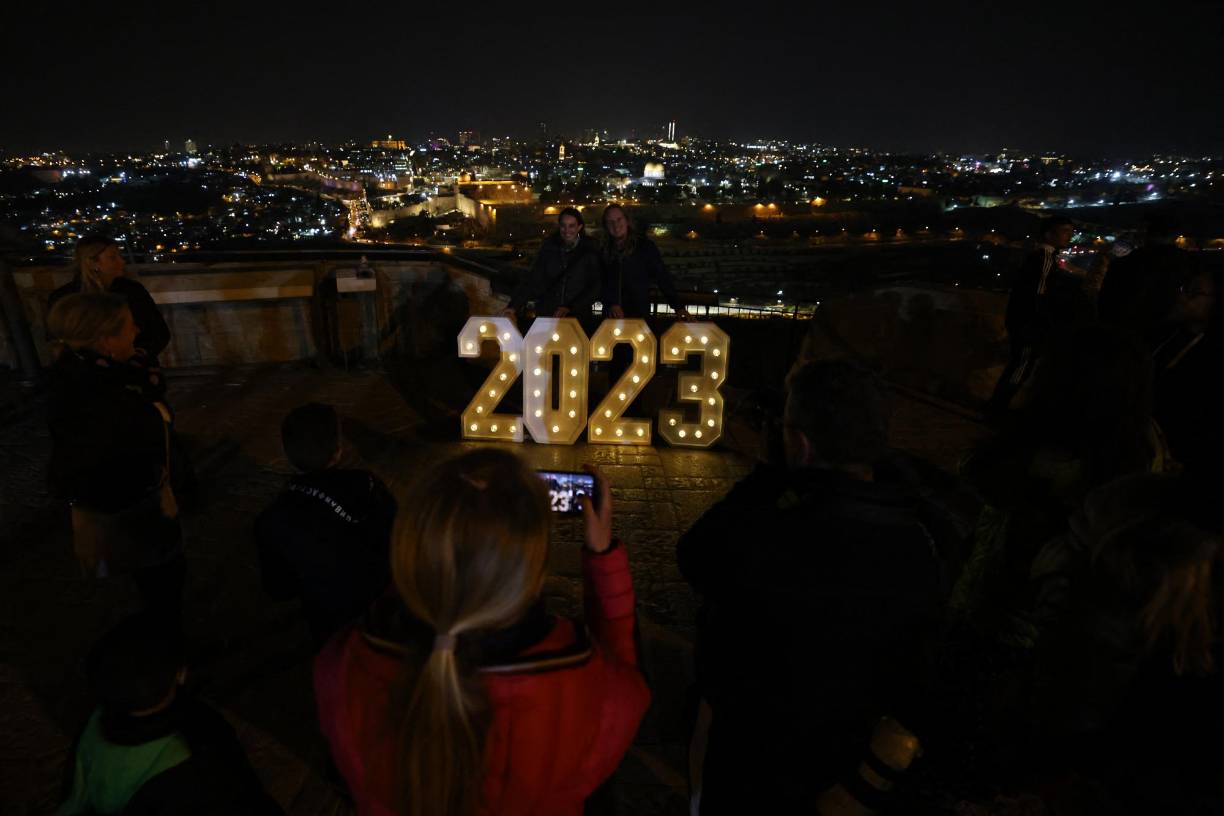 <b>Israel</b>La gente posa para una foto con un letrero iluminado de 2023 en el Monte de los Olivos en Jerusalén. 