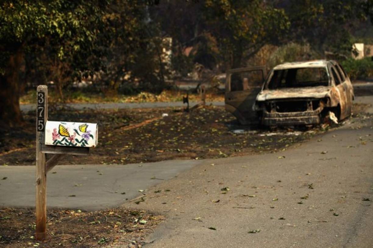 NAPA, CA - OCTOBER 11: A car destroyed by the Tubbs Fire sits on the street on October 11, 2017 in Napa, California. In one of the worst wildfires in state history, more than 2,000 homes have burned and at least 17 people have been killed as more than 14 wildfires continue to spread with little containment in eight Northern California counties. Ezra Shaw/Getty Images/AFP