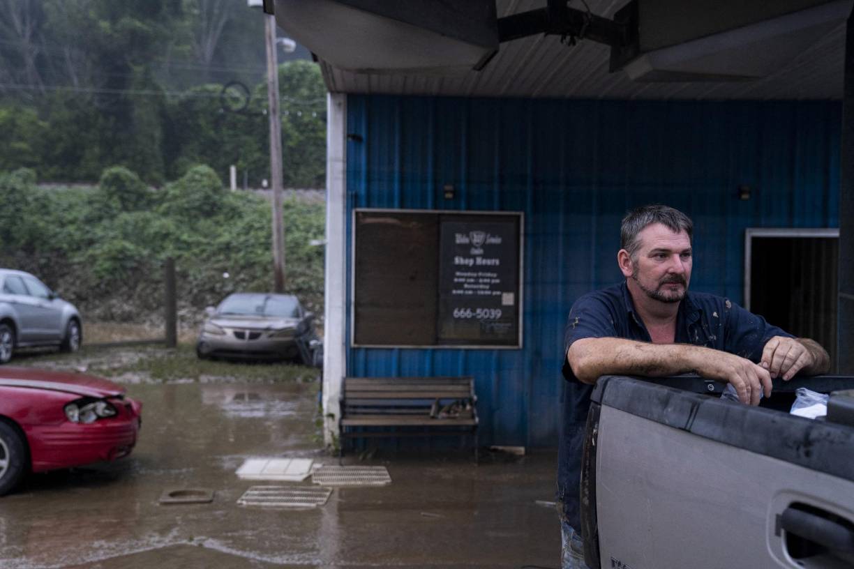 JACKSON, KY - JULY 30: Walter Combs, 45, owner of Walter's Service Center, leans on his truck while taking a break from cleaning out his mechanic shop in Jackson, Kentucky on July 30, 2022. "I believe we'll lose a quarter of our population, I just hope people can get help", says Combs. At least 20 people have been killed and hundreds had to be rescued amid flooding from heavy rainfall. Michael Swensen/Getty Images/AFP (Photo by Michael Swensen / GETTY IMAGES NORTH AMERICA / Getty Images via AFP)