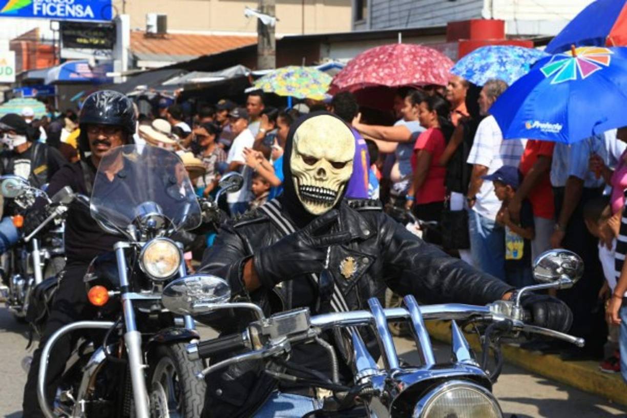 Un hombre en motocicleta hace la señal de amor y paz.