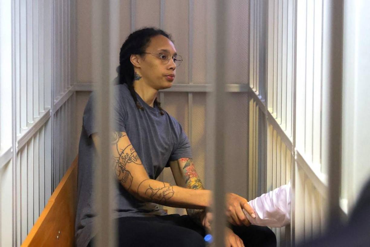 US Women's National Basketball Association (WNBA) basketball player Brittney Griner, who was detained at Moscow's Sheremetyevo airport and later charged with illegal possession of cannabis, sits inside a defendants' cage after the court's verdict during a hearing in Khimki outside Moscow, on August 4, 2022. - A Russian court found Griner guilty of smuggling and storing narcotics after prosecutors requested a sentence of nine and a half years in jail for the athlete. (Photo by EVGENIA NOVOZHENINA / POOL / AFP)