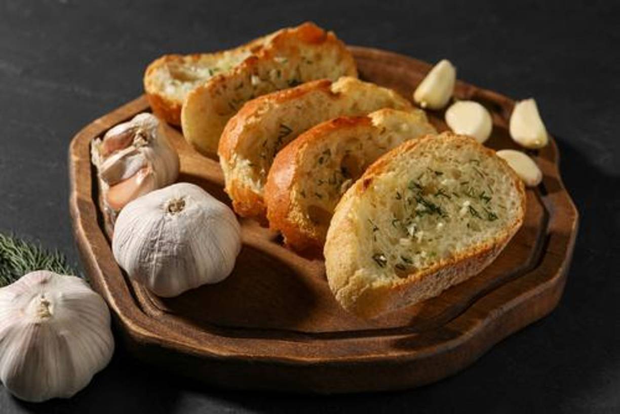 8. Pan de ajo y hierbas: El pan de ajo es un acompañamiento perfecto para cualquier comida festiva. Mezcla mantequilla con ajo picado y hierbas frescas, y úntalo sobre rebanadas de pan antes de hornear.