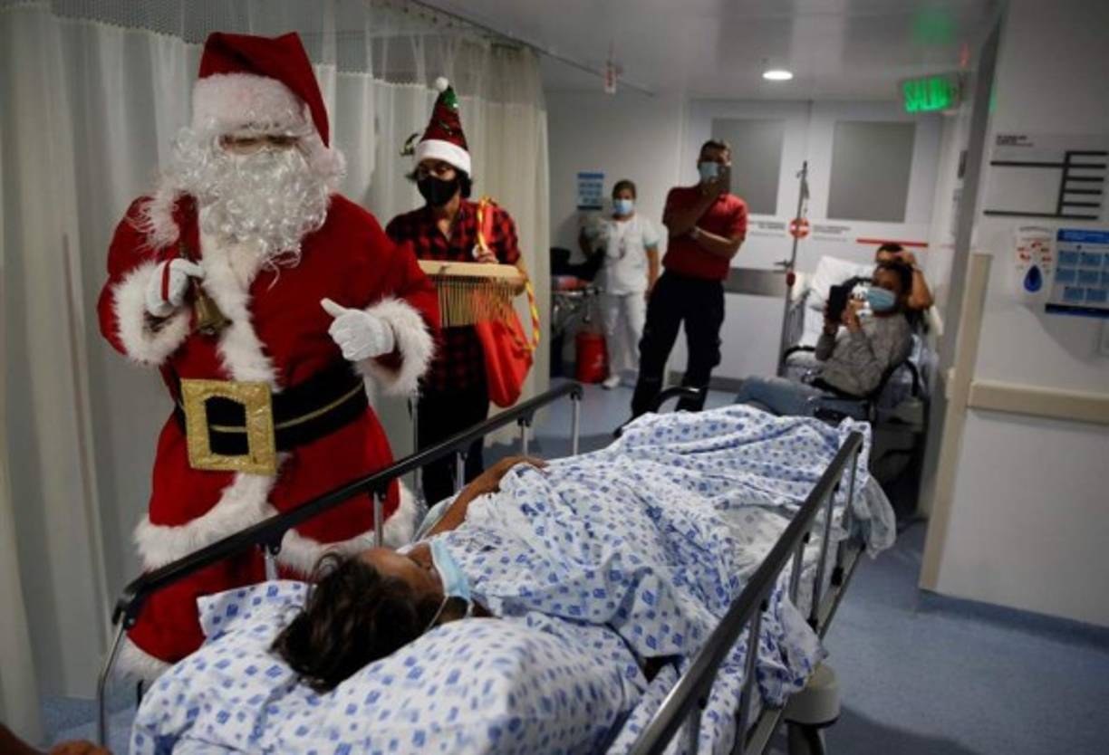 En la ciudad de Cali, Colombia, un Santa Claus visita una clínica deseando feliz Navidad al personal médico y pacientes hospitalizados.