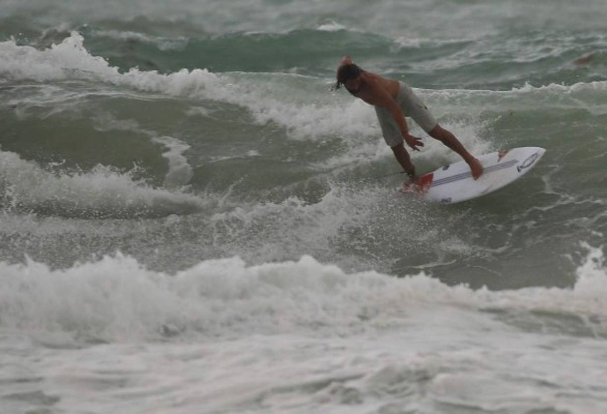 MIAMI BEACH, FL - SEPTEMBER 09: A surfer enjoys the waves churned up buy the approaching Hurricane Irma on September 9, 2017 in Miami Beach, Florida. Florida is in the path of the Hurricane which may come ashore at category 4. Joe Raedle/Getty Images/AFP<br/><br/>== FOR NEWSPAPERS, INTERNET, TELCOS & TELEVISION USE ONLY ==<br/><br/>