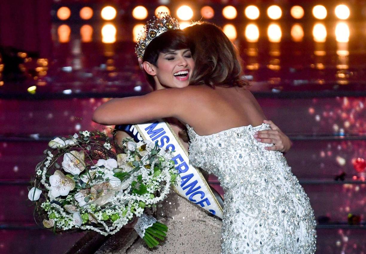 Newly elected Miss France 2024, Miss Nord-Pas-de-Calais Eve Gilles (L), celebrates winning the title with Miss France 2023, Indira Ampiot (R), on stage during the Miss France 2024 beauty pageant in Dijon, central-eastern France, on December 16, 2023. (Photo by ARNAUD FINISTRE / AFP)