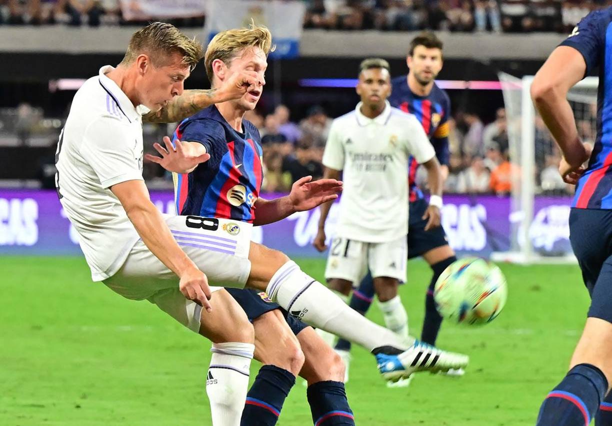 Toni Kroos despejando el balón ante la marca de Frenkie de Jong.