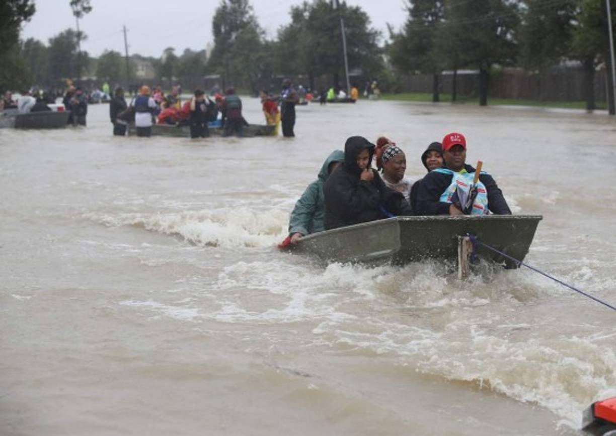 HOUSTON, TX - AUGUST 28: People are pulled in a boat as they evacuate their homes after the area was inundated with flooding from Hurricane Harvey on August 28, 2017 in Houston, Texas. Harvey, which made landfall north of Corpus Christi late Friday evening, is expected to dump upwards to 40 inches of rain in Texas over the next couple of days. Joe Raedle/Getty Images/AFP<br/><br/>== FOR NEWSPAPERS, INTERNET, TELCOS & TELEVISION USE ONLY ==<br/><br/>