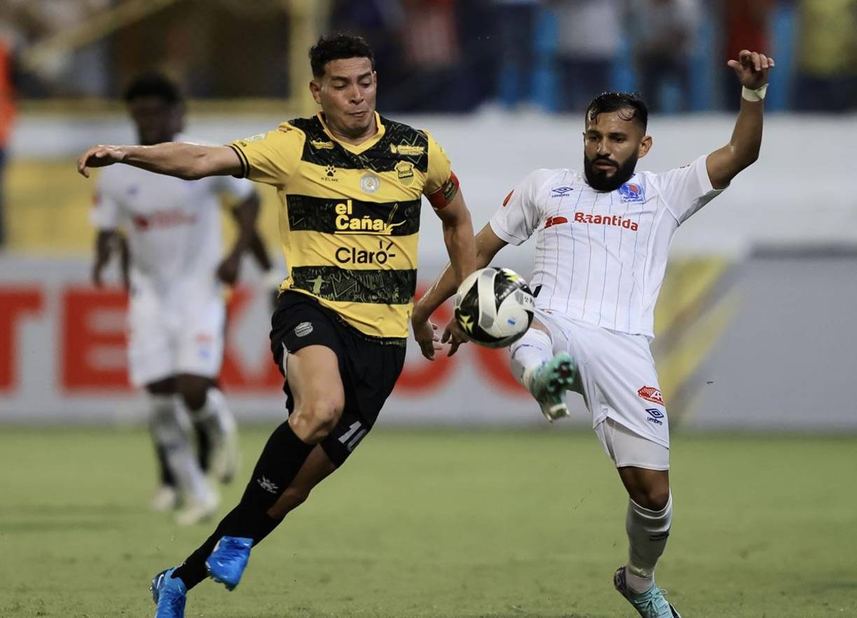 Jhow Benavídez y Jorge Álvarez disputando el balón en un lance del clásico.