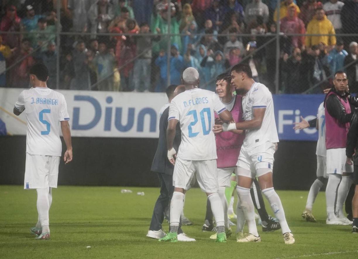 Francisco ‘Chelito‘ Martínez y Luis Vega charlando con Deiby Flores para calmarlo.