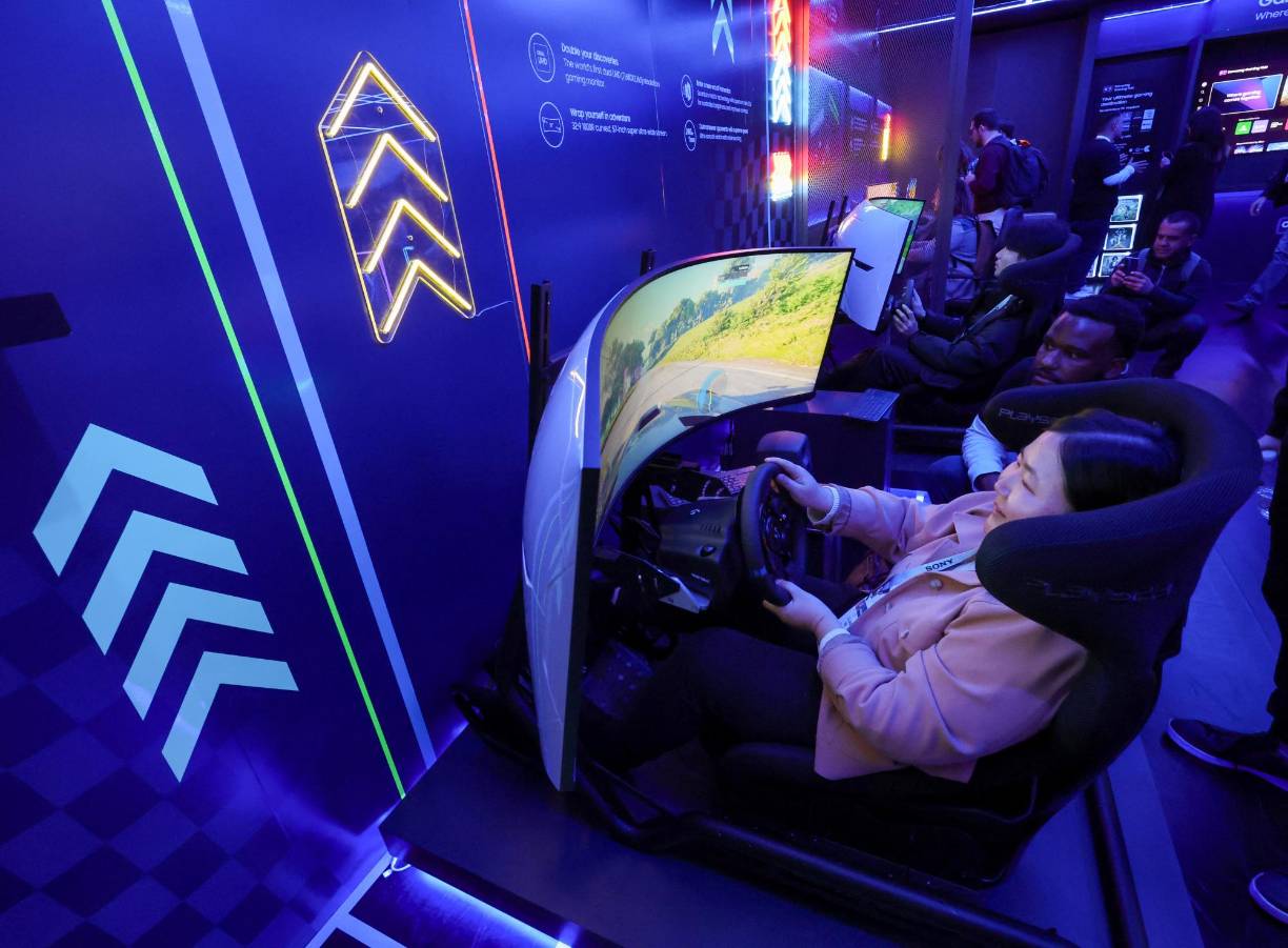LAS VEGAS, NEVADA - JANUARY 10: Lillian Ma plays a racing video game on an Odyssey Neo G9 Series Dual 4K UHD 57-inch curved gaming monitor at the Samsung booth during CES 2024 at the Las Vegas Convention Center on January 10, 2024 in Las Vegas, Nevada. CES, the world's largest annual consumer technology trade show, runs through January 12 and features about 4,000 exhibitors showing off their latest products and services to more than 130,000 attendees. Ethan Miller/Getty Images/AFP (Photo by Ethan Miller / GETTY IMAGES NORTH AMERICA / Getty Images via AFP)