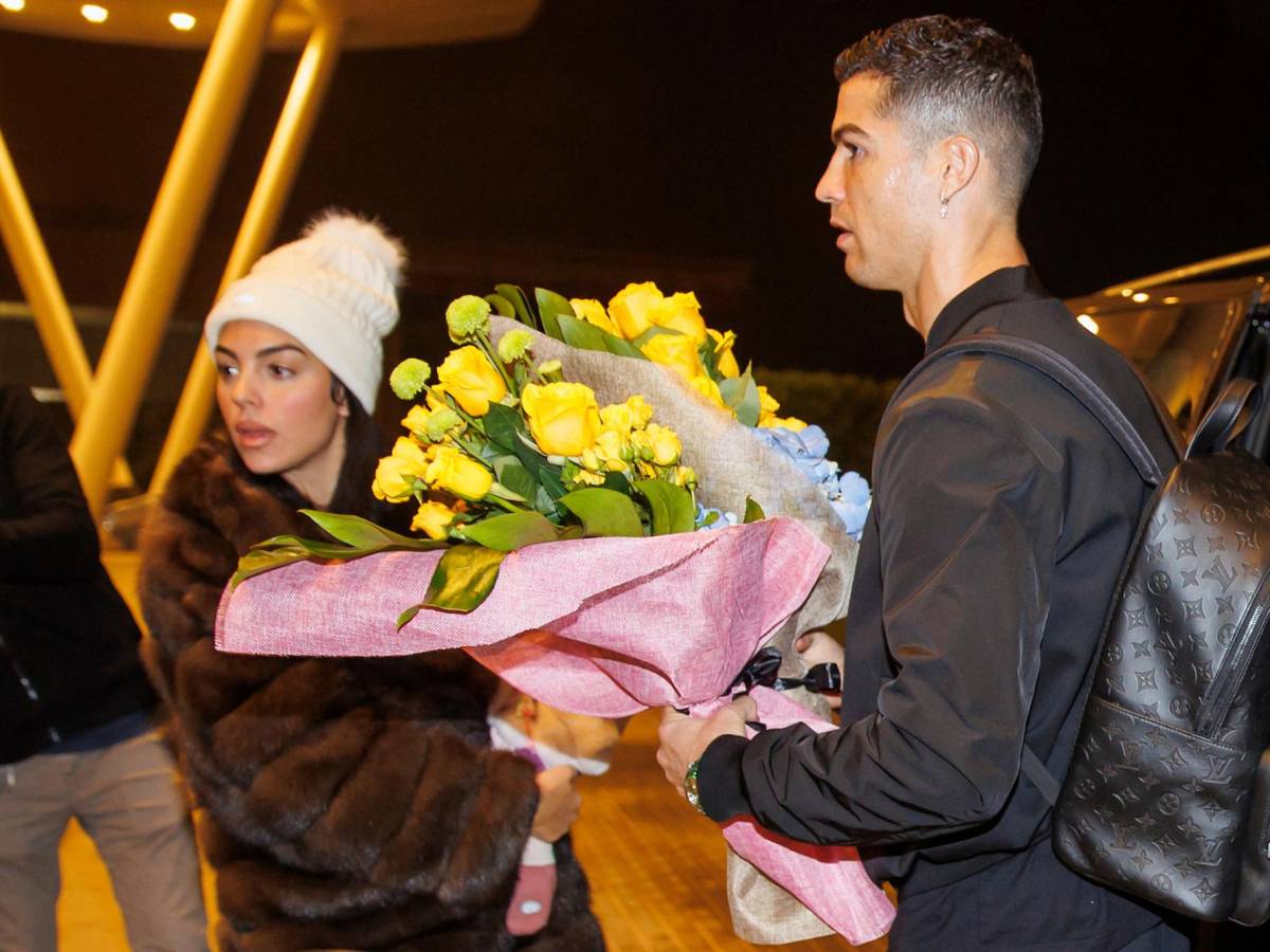 Una foto proporcionada por Al Nassr FC el 2 de enero de 2023 muestra a la estrella de fútbol portuguesa Cristiano Ronaldo (derecha) y su pareja Georgina Rodríguez (izquierda) arribando a un aeropuerto privado en Riyadh antes de ser presentados como jugadores de Al Nassr.