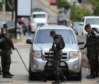 Integrantes de la Policía Militar de Honduras registran un vehículo en el ingreso del Instituto Nacional de Formación Profesional (Infop), lugar donde se encuentra el Centro Logístico Electoral en Tegucigalpa. EFE Gustavo Amador
