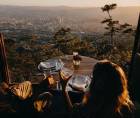 Fotografía muestra a una pareja comiendo en el restaurante La Cumbre. Al fondo se observa la ciudad de Tegucigalpa, Honduras.