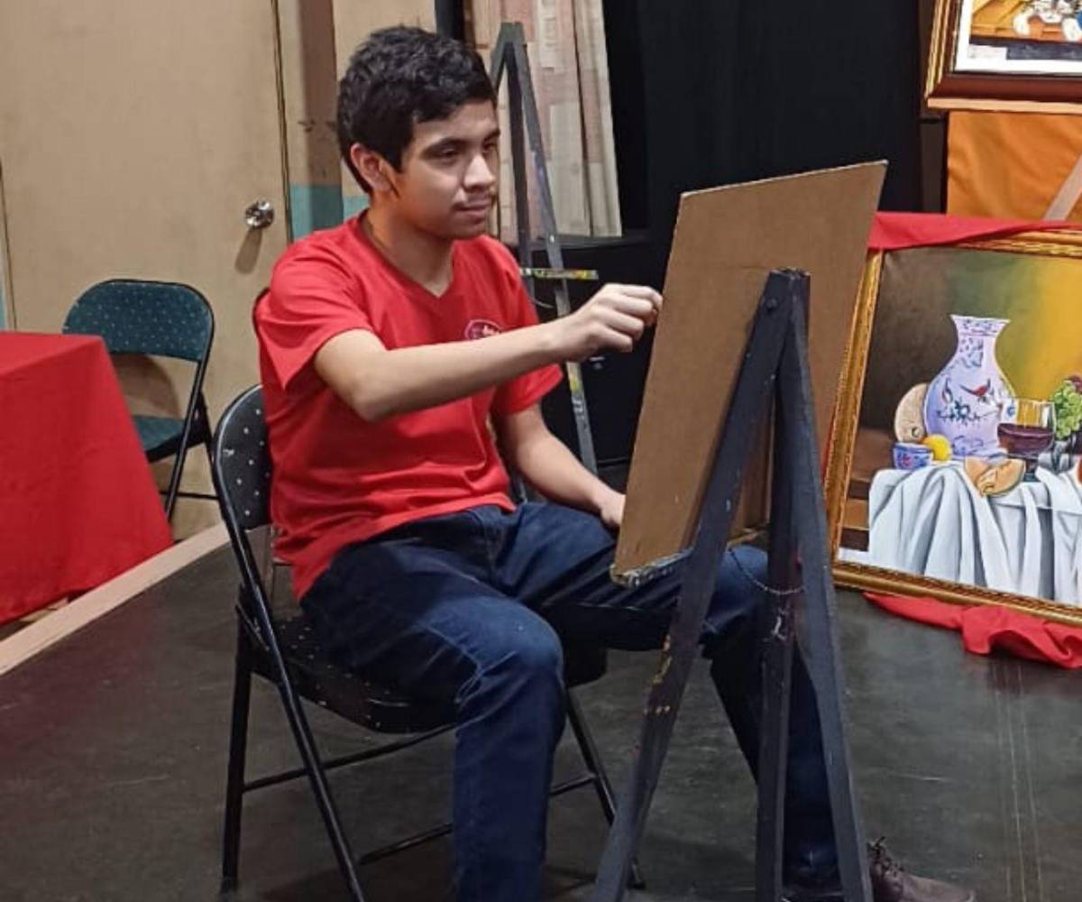 Ramón Ernesto, inmerso en un instante de concentración mientras da vida a su pintura.