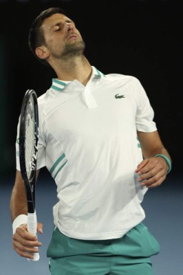 Serbia's Novak Djokovic reacts while playing against Canada's Milos Raonic during their men's singles match on day seven of the Australian Open tennis tournament in Melbourne on February 14, 2021. (Photo by Brandon MALONE / AFP) / -- IMAGE RESTRICTED TO EDITORIAL USE - STRICTLY NO COMMERCIAL USE --