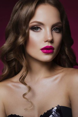 Close-up portrait of beautiful woman with bright make-up and hairstyle.