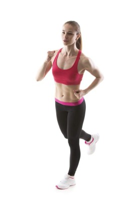 Healthy lifestyle: full length portrait of young fitness girl running, studio shot, white background, isolated